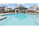 A refreshing community pool with a covered seating area and sun loungers; the perfect spot to relax and unwind at 1053 Knoxboro Ln, Woodstock, GA 30188