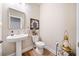 Powder room with pedestal sink, modern decor, and stylish finishes at 1053 Knoxboro Ln, Woodstock, GA 30188