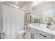 Elegant bathroom features a white vanity, framed mirror, and shower with curtain at 1053 Knoxboro Ln, Woodstock, GA 30188
