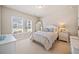 Comfortable bedroom with plush carpeting, natural light, and soft decor, including a mirror at 1053 Knoxboro Ln, Woodstock, GA 30188
