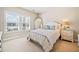 Bright bedroom with plush carpeting, natural light, soft bedding and furniture at 1053 Knoxboro Ln, Woodstock, GA 30188