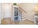 Entryway features hardwood floors, stairs, and a cabinet for storage and display at 1053 Knoxboro Ln, Woodstock, GA 30188