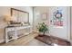 Bright entryway with natural light, decor, and decorative table, with an area rug on the hardwood floors at 1053 Knoxboro Ln, Woodstock, GA 30188