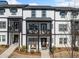 Townhome exterior showcasing black and white facade, porches, and well-maintained landscaping at 1053 Knoxboro Ln, Woodstock, GA 30188
