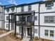 Townhome exterior with black trim, covered porch, and balcony on the second level at 1053 Knoxboro Ln, Woodstock, GA 30188