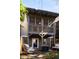 Charming backyard with lounge chairs, fire pit, well-manicured landscaping, and an upstairs balcony at 380 Grant Se Cir # 110, Atlanta, GA 30315
