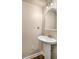 Bathroom with a pedestal sink, framed mirror, and modern lighting at 380 Grant Se Cir # 110, Atlanta, GA 30315