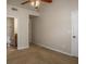 Neutral bedroom with tan carpet and ceiling fan with access to the bathroom with toilet and vanity at 380 Grant Se Cir # 110, Atlanta, GA 30315