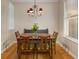 Dining room featuring hardwood floors, a chandelier, and a large window at 380 Grant Se Cir # 110, Atlanta, GA 30315