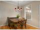 Charming dining room with a wood table set under a chandelier and next to a window at 380 Grant Se Cir # 110, Atlanta, GA 30315