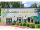 Exterior of a white building featuring a mural for Elsewhere Brewing at 380 Grant Se Cir # 110, Atlanta, GA 30315