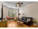 Bright living room with bay window, wood floors, ceiling fan and comfortable seating at 380 Grant Se Cir # 110, Atlanta, GA 30315