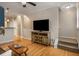 Open concept living room showcasing hardwood floors, stairs, and ample natural light at 380 Grant Se Cir # 110, Atlanta, GA 30315