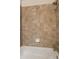 Shower with brown tiles, shower head, white tub, and soap holder at 380 Grant Se Cir # 110, Atlanta, GA 30315