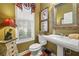 Charming half-bathroom with a pedestal sink and decorative accents at 4770 Shiloh Springs Rd, Cumming, GA 30040