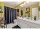 Spacious bathroom featuring a double sink vanity, garden tub with shower, and stylish fixtures at 4770 Shiloh Springs Rd, Cumming, GA 30040