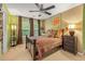 Cozy bedroom featuring a ceiling fan, unique decor, and natural light from a window at 4770 Shiloh Springs Rd, Cumming, GA 30040
