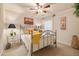 Light-filled bedroom featuring an iron bed frame, neutral walls, and soft carpet at 4770 Shiloh Springs Rd, Cumming, GA 30040