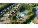 Community pool and tennis courts, highlighted in an aerial view, surrounded by lush trees, seating, and homes at 4770 Shiloh Springs Rd, Cumming, GA 30040