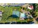 Aerial view of a community pool and tennis courts surrounded by lush trees and landscaping at 4770 Shiloh Springs Rd, Cumming, GA 30040