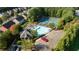 An aerial view of the neighborhood community pool and tennis courts features comfortable seating and a nearby playground at 4770 Shiloh Springs Rd, Cumming, GA 30040