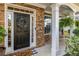 Inviting front porch featuring stone columns, decorative wreath, and a cozy seating area at 4770 Shiloh Springs Rd, Cumming, GA 30040