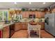 Charming kitchen featuring granite countertops, stainless steel appliances, and a mobile island at 4770 Shiloh Springs Rd, Cumming, GA 30040