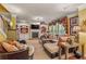Comfortable living room with a fireplace, built-in shelving and large windows at 4770 Shiloh Springs Rd, Cumming, GA 30040