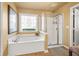 Main bathroom with a soaking tub and separate shower at 4770 Shiloh Springs Rd, Cumming, GA 30040