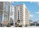 Exterior shot of the condo building on a sunny day with blue skies at 2161 Peachtree Ne Rd # 405, Atlanta, GA 30309