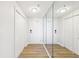 Bright hallway featuring mirrored walls and hardwood style floors at 2161 Peachtree Ne Rd # 405, Atlanta, GA 30309