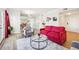 Bright living room with a red couch, armchair, and glass coffee table, filled with natural light at 2161 Peachtree Ne Rd # 405, Atlanta, GA 30309
