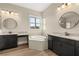 Bathroom with and sinks, a soaking tub, and granite countertops at 231 Laurel Vista Dr, Canton, GA 30114