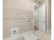 Large laundry room with a storage shelf and tile floors at 231 Laurel Vista Dr, Canton, GA 30114