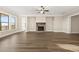 A spacious living room with large windows, a fireplace, and beautiful wood flooring at 231 Laurel Vista Dr, Canton, GA 30114