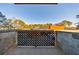 Balcony with concrete floor and decorative iron railing, with view of parking lot and trees at 300 Johnson Ferry Ne Rd # B113, Atlanta, GA 30328