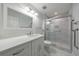 Bright bathroom featuring a vanity with marble countertop and a glass-enclosed shower with marble tile at 300 Johnson Ferry Ne Rd # B113, Atlanta, GA 30328