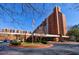 Apartment complex with brick facade, manicured landscaping, and American flag at 300 Johnson Ferry Ne Rd # B113, Atlanta, GA 30328