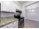 Kitchen with granite counters, stainless oven, white cabinets and wood floors at 300 Johnson Ferry Ne Rd # B113, Atlanta, GA 30328
