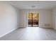 Bright living room features neutral walls, gray wood floors, and sliding glass doors to a balcony at 300 Johnson Ferry Ne Rd # B113, Atlanta, GA 30328