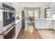 Modern kitchen with stainless steel oven and white cabinetry, with a bright breakfast nook nearby at 708 Collier Commons Nw Cir, Atlanta, GA 30318