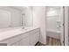 Well-lit bathroom with white cabinets, dual sinks, and a shower-tub combo at 8516 Polston Place Dr, Douglasville, GA 30134