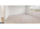 A bright, carpeted bedroom with a large window at 8516 Polston Place Dr, Douglasville, GA 30134