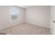 Bright, carpeted bedroom featuring a window allowing natural light with neutral walls at 8516 Polston Place Dr, Douglasville, GA 30134