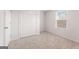 Cozy bedroom with neutral carpet features a double door closet and window at 8516 Polston Place Dr, Douglasville, GA 30134