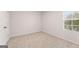 Bright carpeted bedroom featuring a window with natural light with neutral walls at 8516 Polston Place Dr, Douglasville, GA 30134
