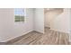 Bright entryway featuring stylish wood-look flooring and a staircase leading to the upper level of the home at 8516 Polston Place Dr, Douglasville, GA 30134