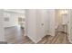 Open-concept home featuring stylish flooring, connecting a half bathroom, entryway, and the kitchen at 8516 Polston Place Dr, Douglasville, GA 30134