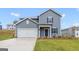 Attractive two-story home features a blue gray exterior, two-car garage, and a well-manicured lawn at 8516 Polston Place Dr, Douglasville, GA 30134