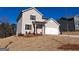 Well-maintained gray house with an attached two-car garage, tidy landscaping, and a neatly graded front yard at 8516 Polston Place Dr, Douglasville, GA 30134